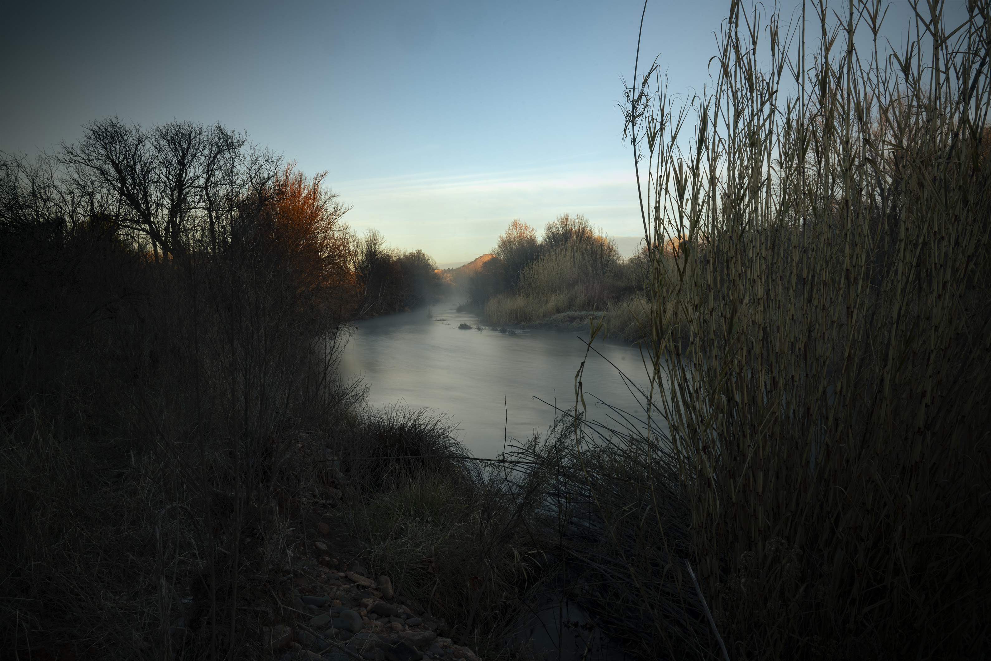 Oak Creek at sunrise with golden cottonwoods and red rock walls