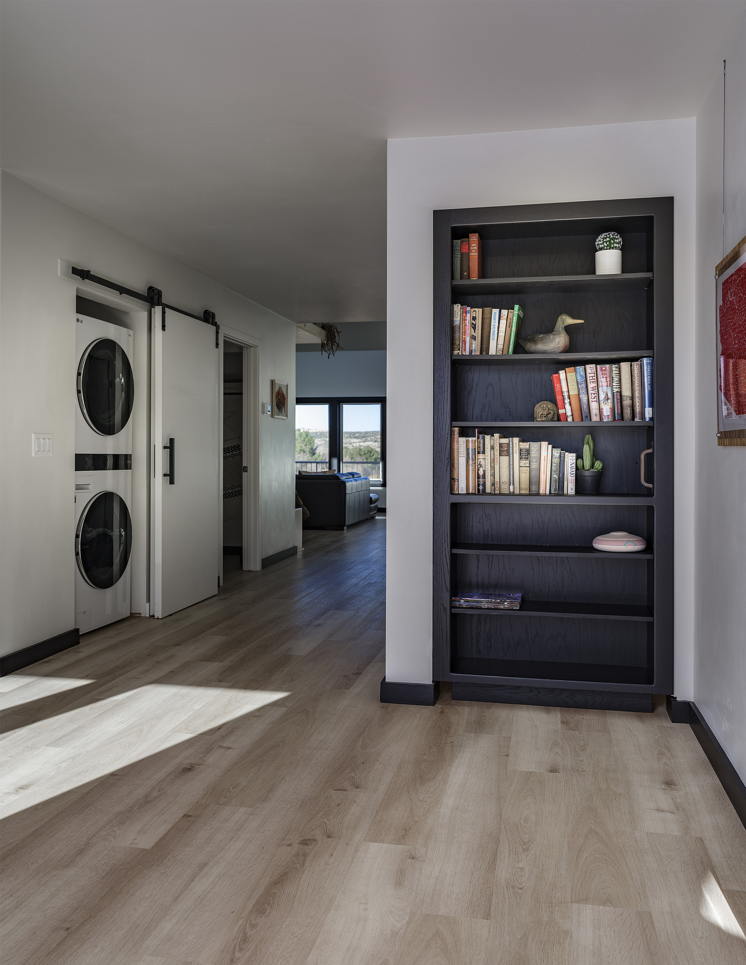 Built-in bookshelf with curated books and decor hiding a secret door