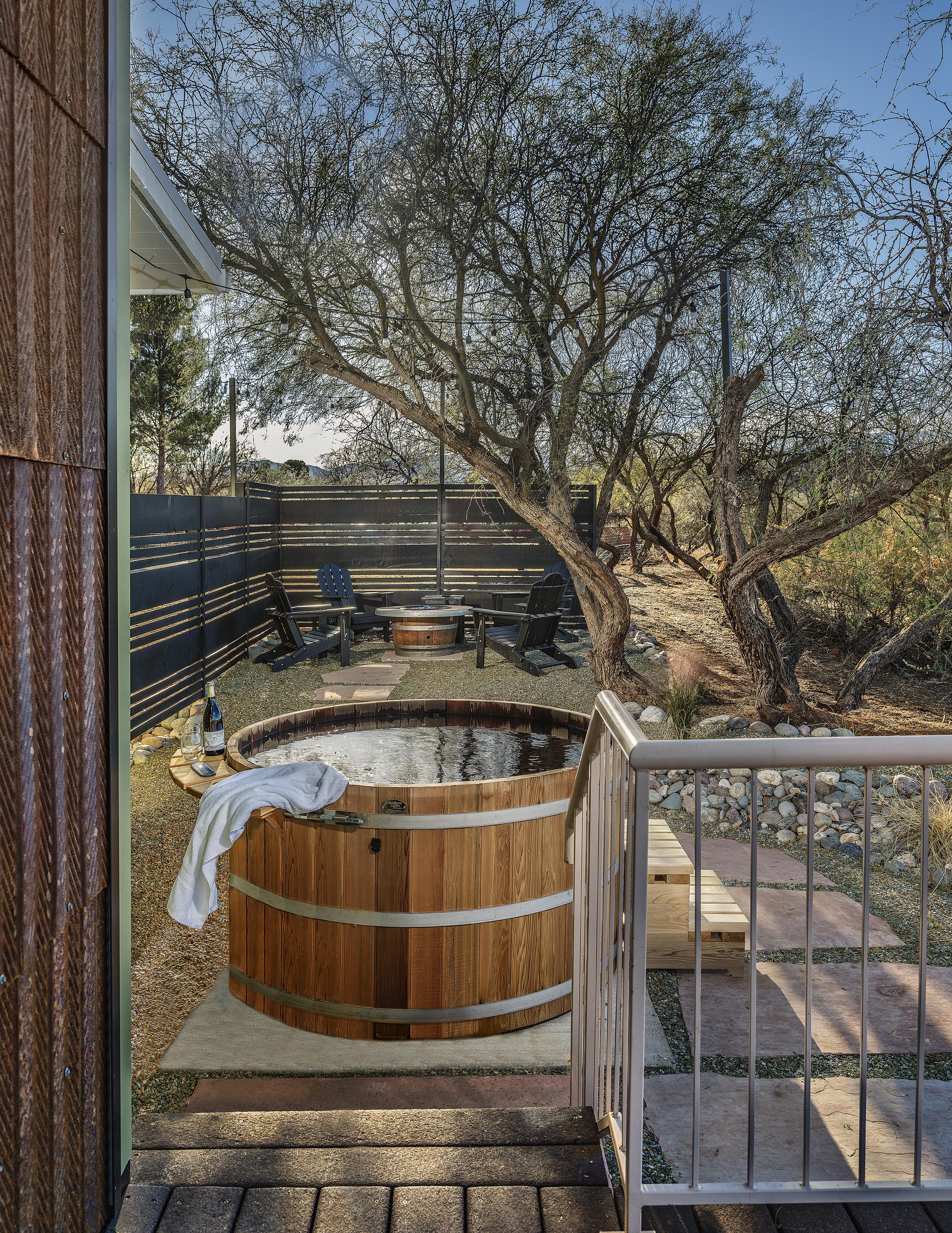 Cedar barrel hot tub on expansive deck with valley views